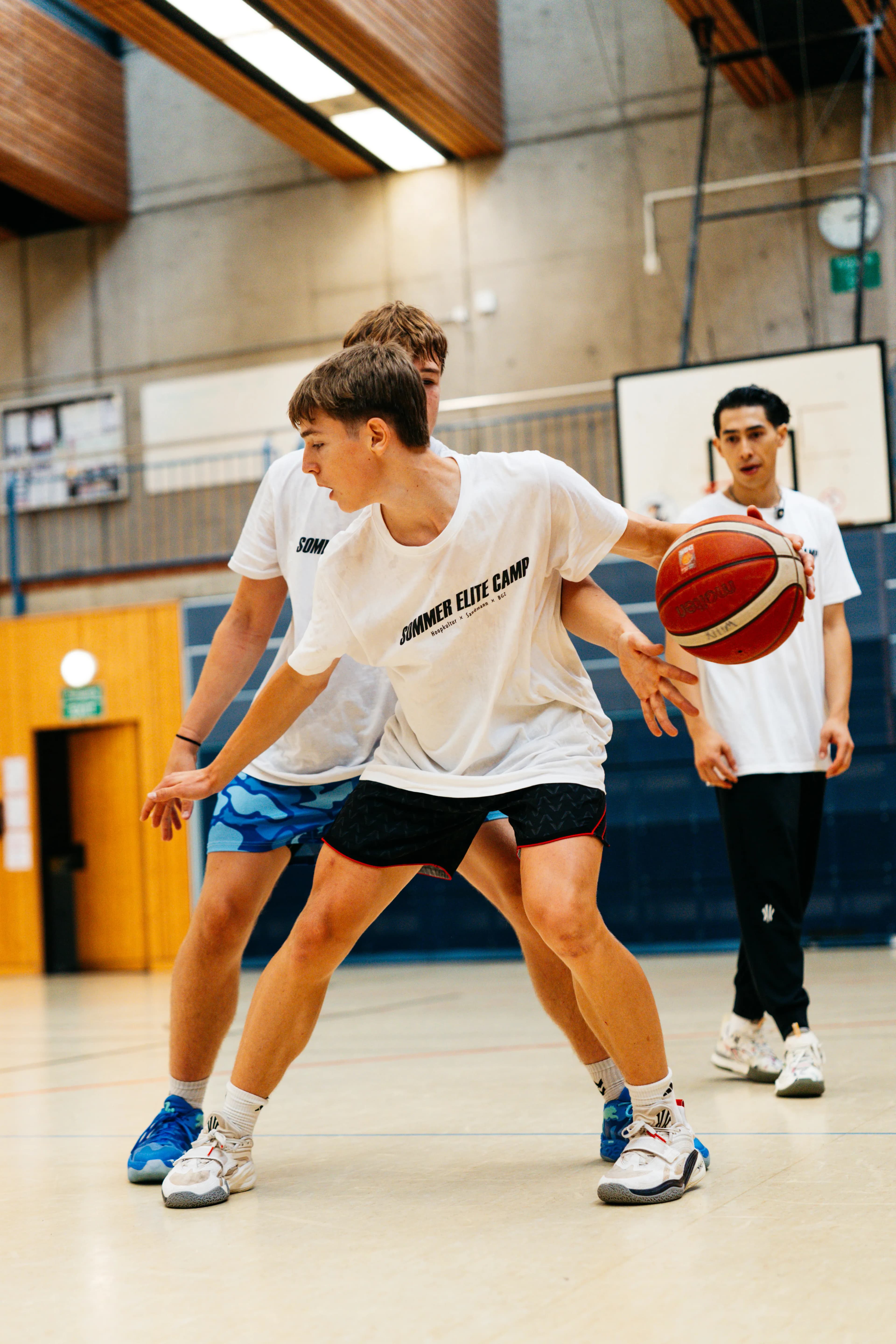 Player driving past a defender in a one-on-one drill at the Sommer Elite Camp